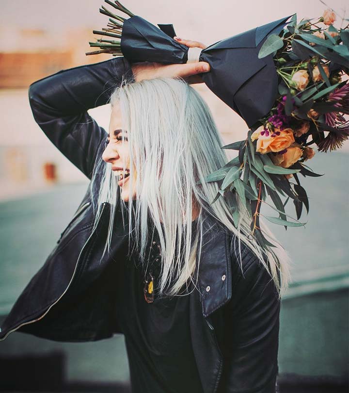 A woman smiling with platinum hair shade
