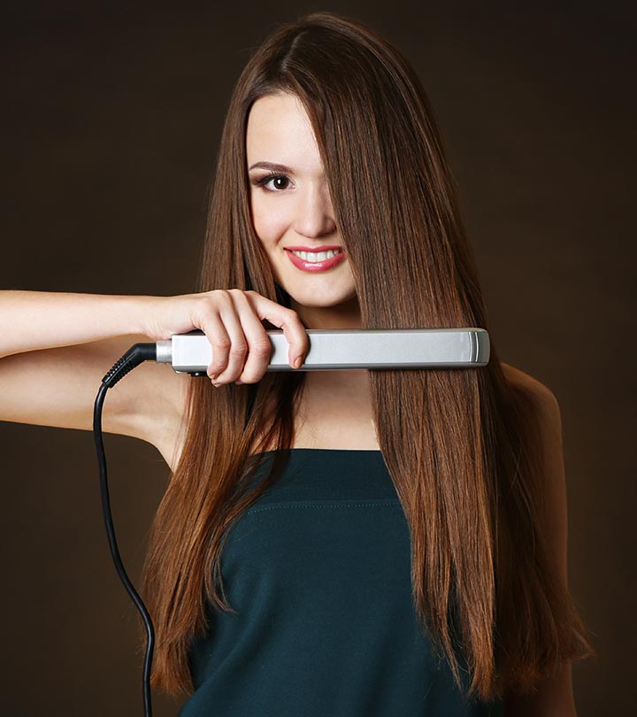 A girl straightening her hair with a flat iron