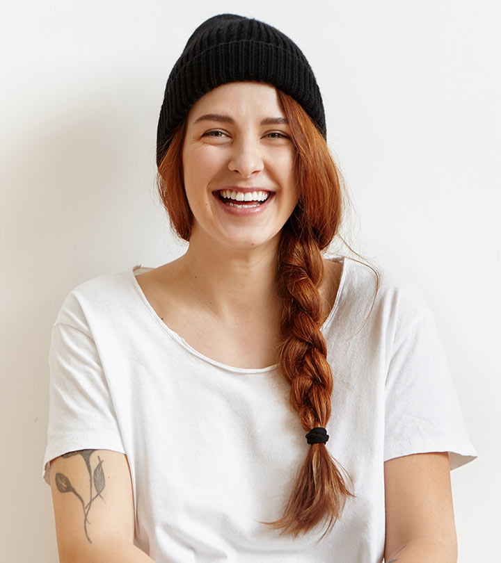 A smiling woman with a side braid hairstyle
