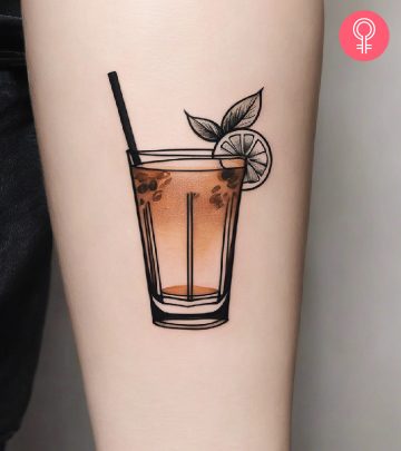 A sepia-tone orange cocktail with an orange wedge on the forearm. A sepia-tone orange cocktail with an orange wedge on the forearm.