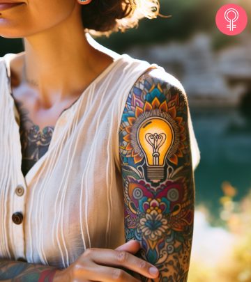 A woman with a lightbulb tattoo on her upper arm A woman with a lightbulb tattoo on her upper arm
