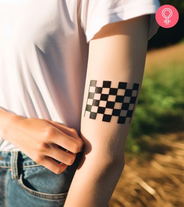 A woman with a checkered flag tattoo on her arm A woman with a checkered flag tattoo on her arm