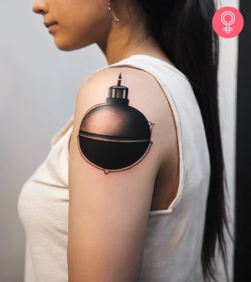 A bomb tattoo on a woman’s upper arm A bomb tattoo on a woman’s upper arm