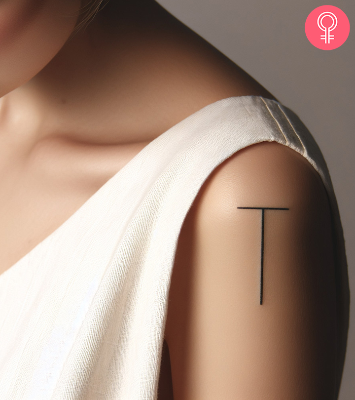 8 Creative Letter T Tattoo Designs And Ideas A woman wearing a ‘T’ style letter tattoo on the upper arm.