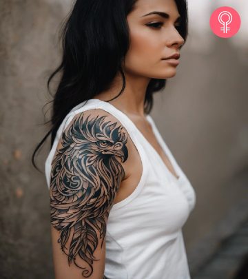 A griffin head tattoo on a woman’s upper arm A griffin head tattoo on a woman’s upper arm