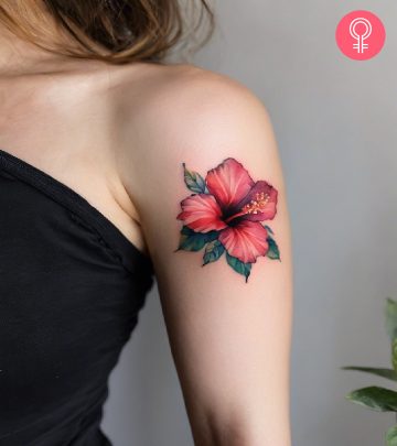 A woman with a hibiscus tattoo on her upper arm A woman with a hibiscus tattoo on her upper arm