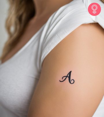 8 Inspiring Alphabet Tattoo Designs And Ideas With Meanings A woman wearing a ‘T’ style letter tattoo on the upper arm.