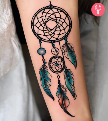 Woman with a dreamcatcher tattoo on the forearm Woman with a dreamcatcher tattoo on the forearm