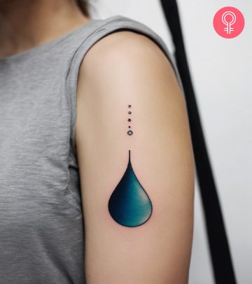 A woman with a colored water drop tattoo on her upper arm A woman with a colored water drop tattoo on her upper arm