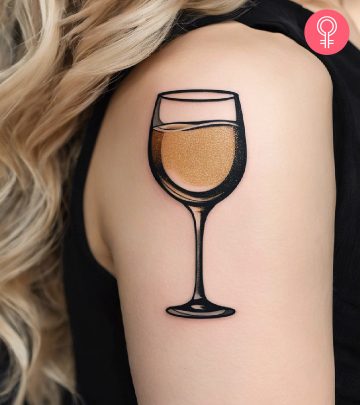 A champagne tattoo on the upper arm of a woman A champagne tattoo on the upper arm of a woman