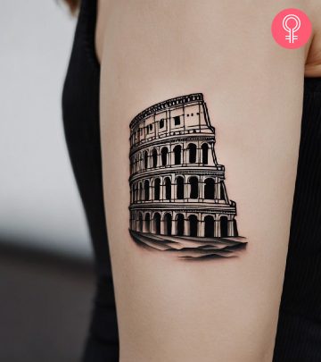 A Colosseum tattoo on a woman’s upper arm A Colosseum tattoo on a woman’s upper arm