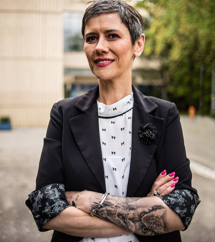 A female lawyer stands with crossed arms with a tattoo A female lawyer stands with crossed arms with a tattoo