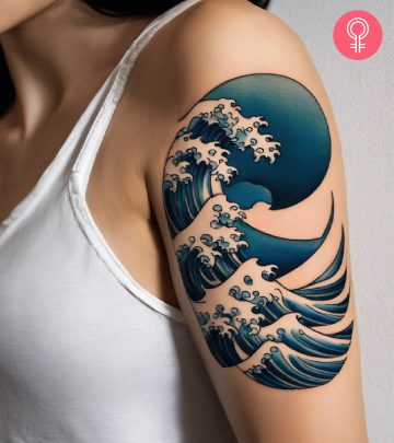 A Japanese wave tattoo on the upper arm of a woman A Japanese wave tattoo on the upper arm of a woman