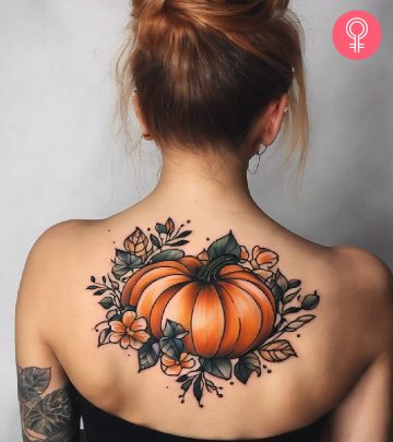 A pumpkin tattoo on the back of a woman A pumpkin tattoo on the back of a woman