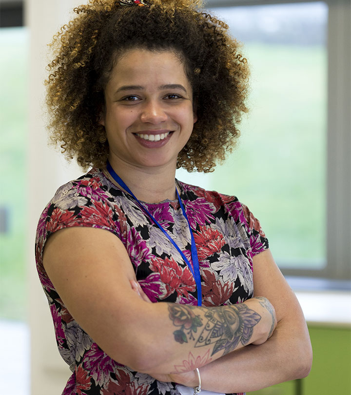 A teacher sporting a tattoo with a flower motif on her forearm A teacher sporting a tattoo with a flower motif on her forearm