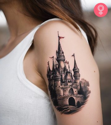 A woman with a black castle tattoo on her upper arm A woman with a black castle tattoo on her upper arm