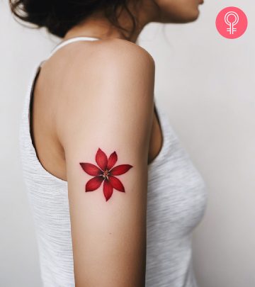 A woman with a red floral tattoo on the upper arm A woman with a red floral tattoo on the upper arm