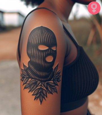 A woman with a ski mask tattoo on the upper arm A woman with a ski mask tattoo on the upper arm
