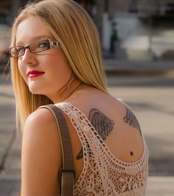 A woman with tattoos on her back above a mole
