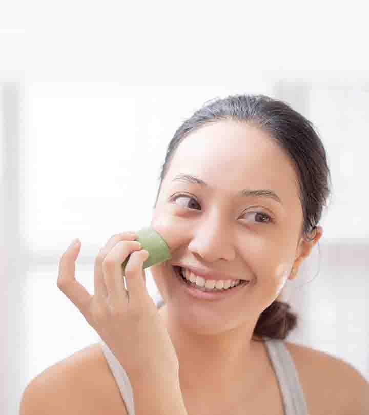A girl applying aloe vera on her face