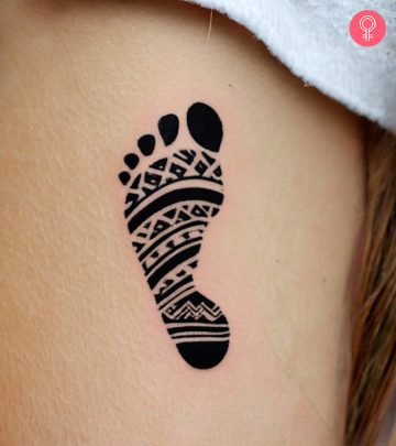 Baby footprint tattoo on a woman’s arm Baby footprint tattoo on a woman’s arm