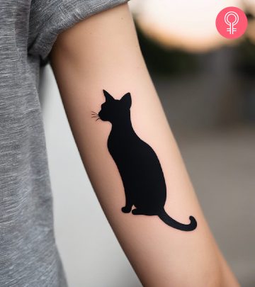 Cat silhouette tattoo on the arm of a woman Cat silhouette tattoo on the arm of a woman