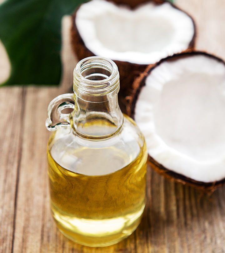 Coconut and coconut hair oil in a glass bottle