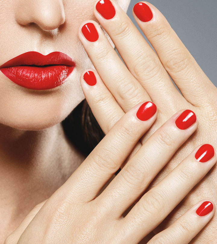 Girl fingers with red color nail polish