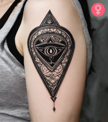 A planchette tattoo on a woman’s upper arm A planchette tattoo on a woman’s upper arm