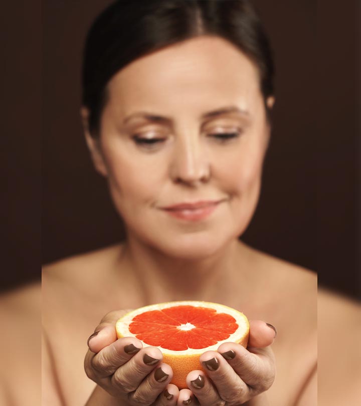 Woman Using Grapefruit For Skincare