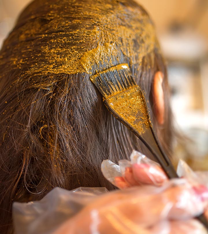 A girl applying henna on her hair