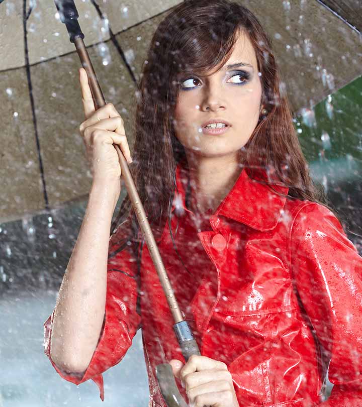 A girl holding an umbrella when it is raining