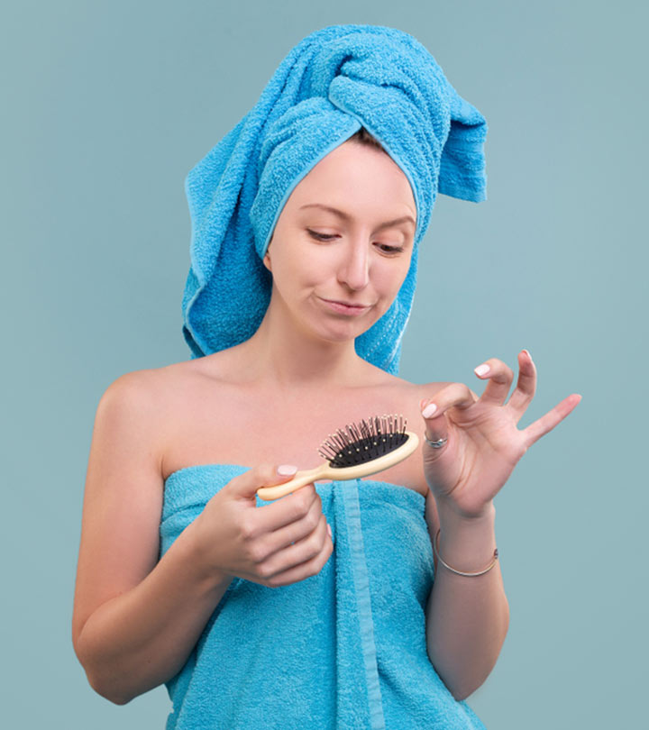 Women Cleaning A Boar Bristle Hairbrush