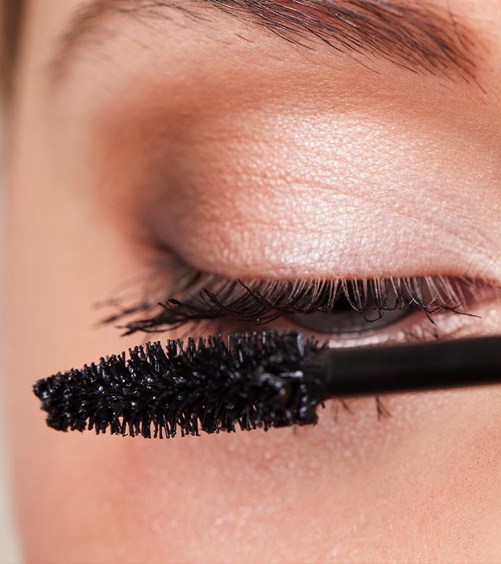 A girl is applying mascara