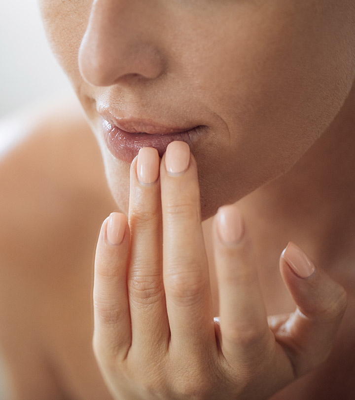 Women apply some lip balm on their dark lips
