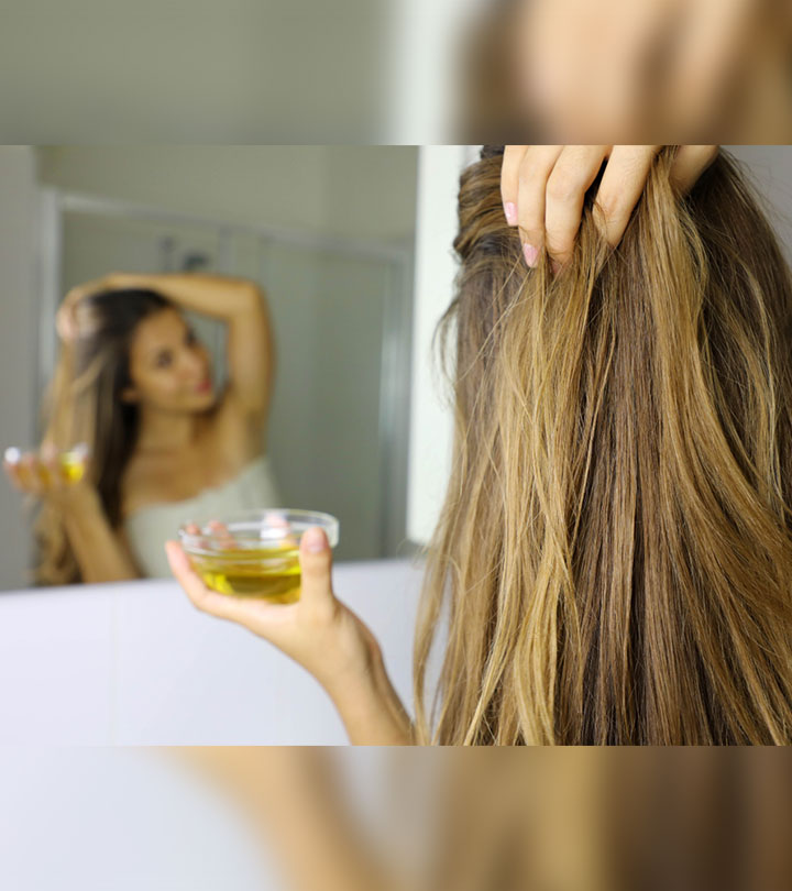 A Women Applying Hot Oil Treatment To Her Hair A Women Applying Hot Oil Treatment To Her Hair