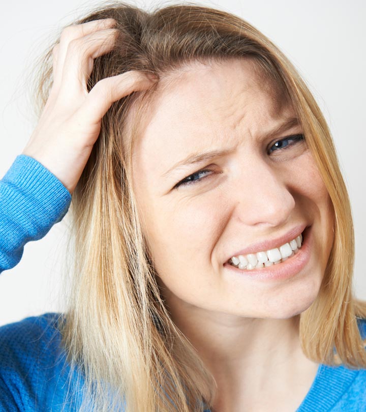 A girl scratching her scalp