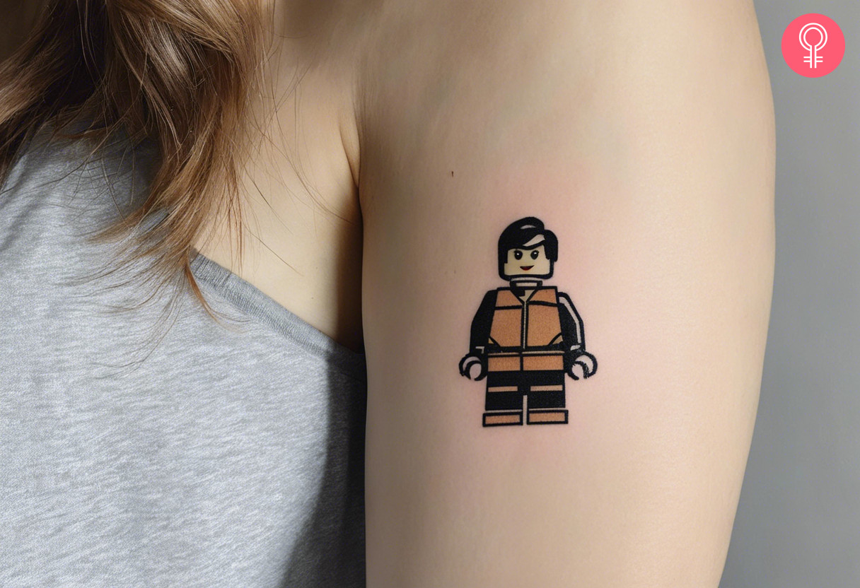 A woman with a colored LEGO man tattoo on her upper arm