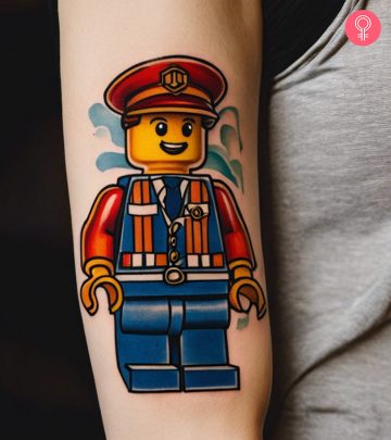 A woman with a colored Emmet, from The LEGO Movie, tattoo on the upper arm A woman with a colored Emmet, from The LEGO Movie, tattoo on the upper arm