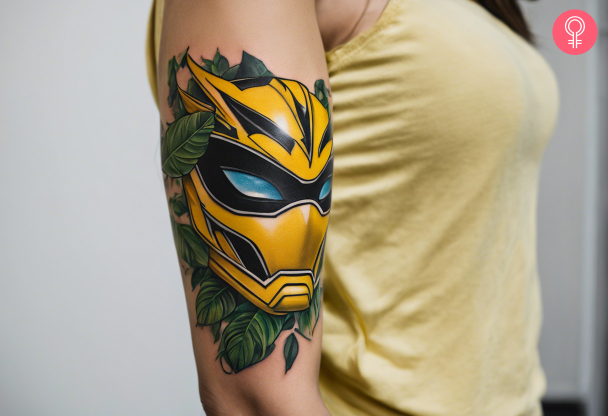 A yellow Power Rangers Jungle Fury-inspired tattoo on the arm