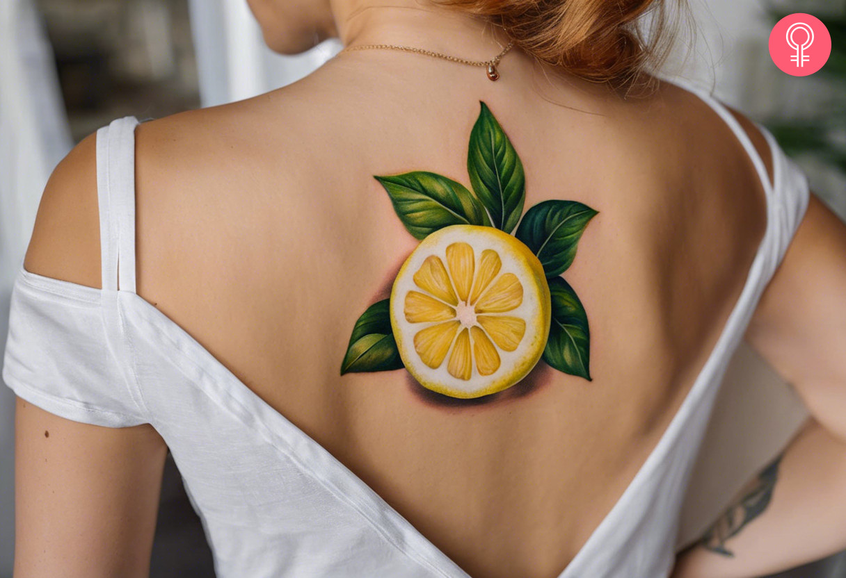 Realistic lemon tattoo on the upper back