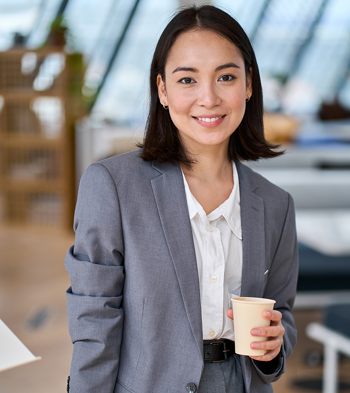 A professional woman holding a coffee cup