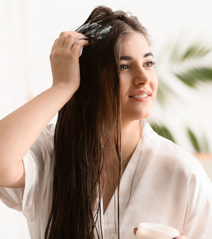 Woman Applying Shea Butter To Her Hair Woman Applying Shea Butter To Her Hair