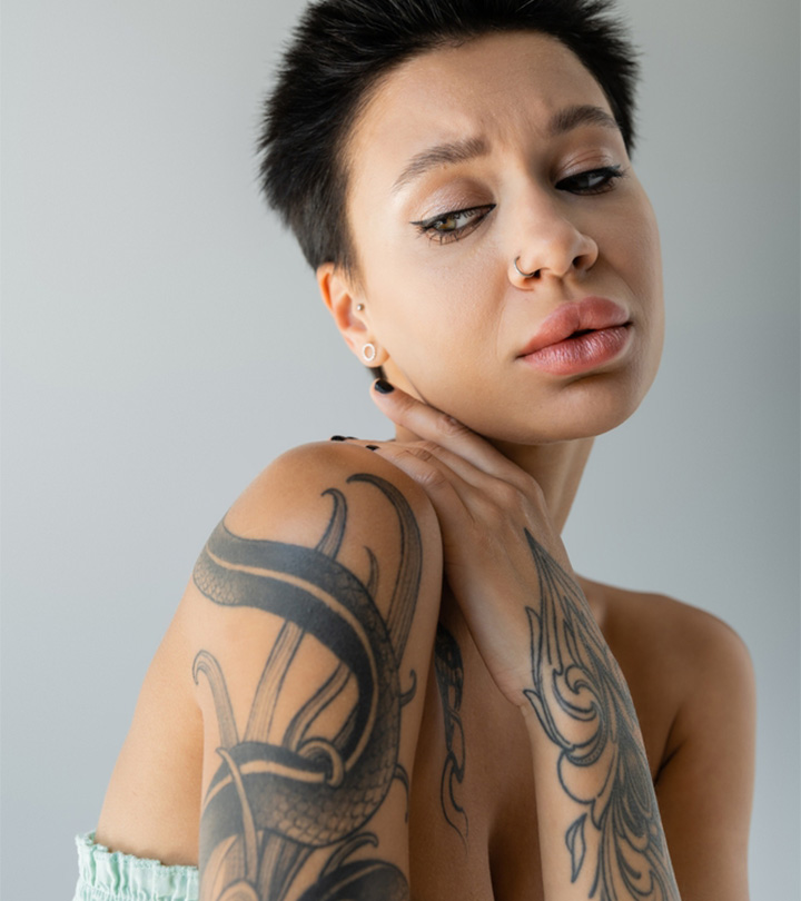 An upset tattooed woman