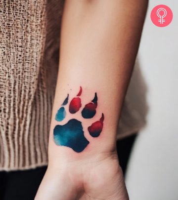 8 Creative Wolf Paw Tattoo Ideas With Meanings Mandalorian helmet with flowers on the forearm