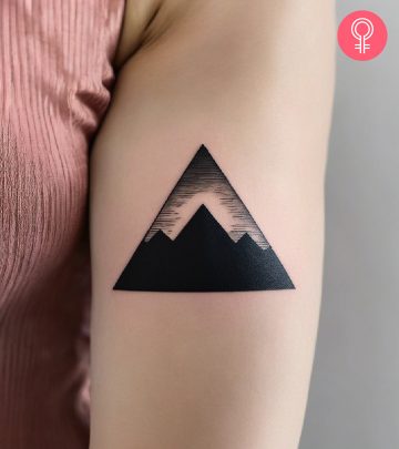Woman with a pyramid tattoo on the upper arm Woman with a pyramid tattoo on the upper arm